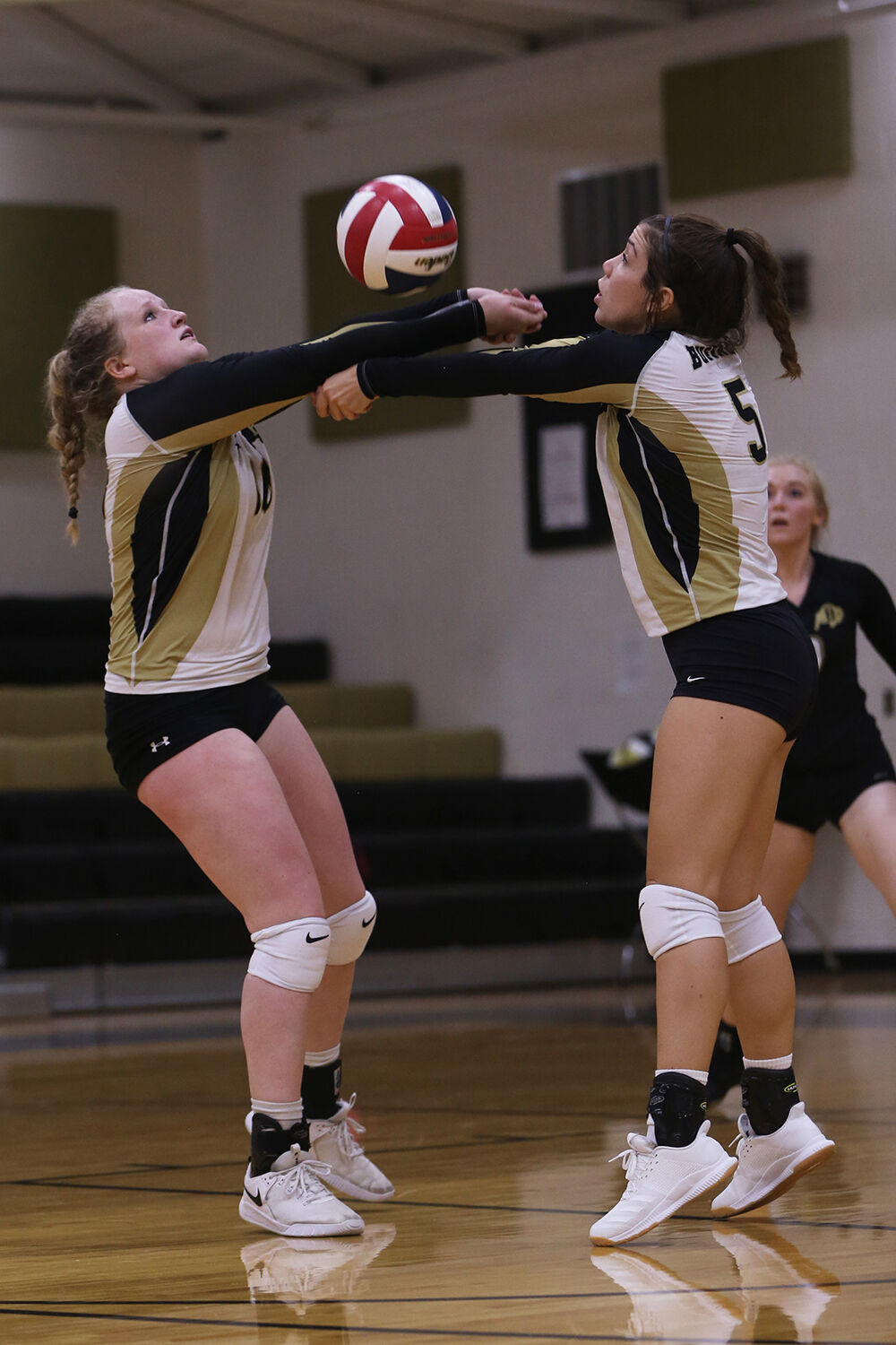 Tessa Taylor, left, and Riley Fowler both stretch up to receive a pass